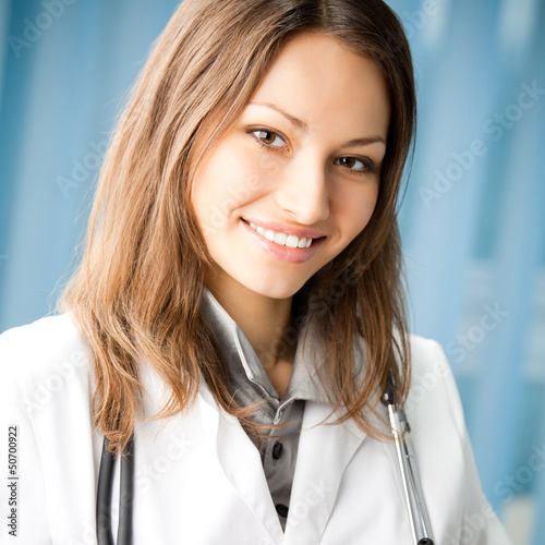 Photo: Cheerful female doctor at office Cheerful female doctor at office