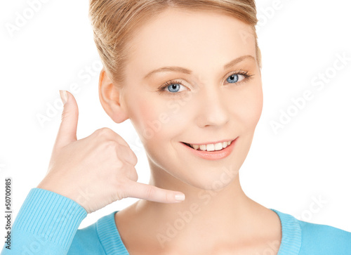 Photo: woman making a call me gesture woman making a call me gesture