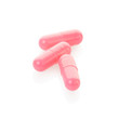 Pink medical capsule on white, clipping path included