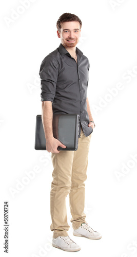Photo: Happy young man with laptop - isolated on white Happy young man with laptop - isolated on white