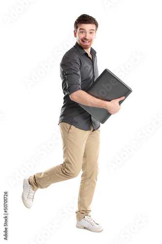 Photo: Happy young man with laptop - isolated on white Happy young man with laptop - isolated on white