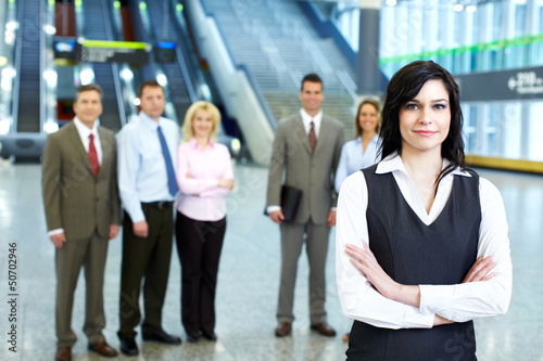 Photo: Business woman and a group of workers. Business woman and a group of workers.