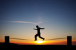 silhouette of slackliner in sunset