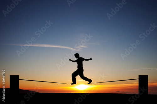 Photo: silhouette of slackliner in sunset silhouette of slackliner in sunset
