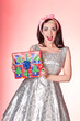 Photo: Excited vintage lady with Christmas present Excited vintage lady with Christmas present