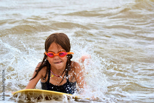 Photo: Young Girl Body Surfing at the Beach Young Girl Body Surfing at the Beach
