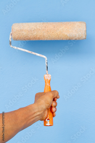 Photo: Holding Painting roller in hand Holding Painting roller in hand