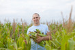 Happy  farmer in field of corn