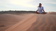 Woman doing yoga in the wilderness at sunset against a beautiful