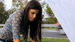 Beautiful woman checking broken car engine