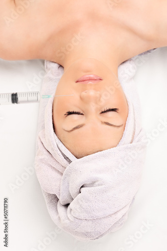 Photo: A young woman during a beauty treatment A young woman during a beauty treatment