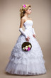 Wedding. Bride in White Dress and Gloves. Bouquet of Flowers