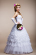 Wedding. Newlywed in White Dress holding Bouquet of Flowers