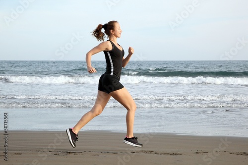 Photo: Healthy woman running on the beach Healthy woman running on the beach