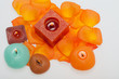 Spilt petals of the orange-rose around the aromatic candle