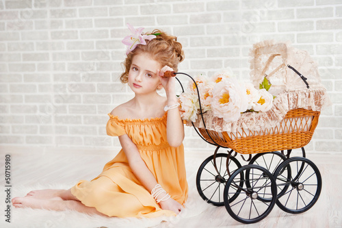 Photo: Girl in orange dress with vintage pram Girl in orange dress with vintage pram