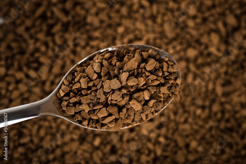 Photo: Spoon of coffee at coffe background Spoon of coffee at coffe background