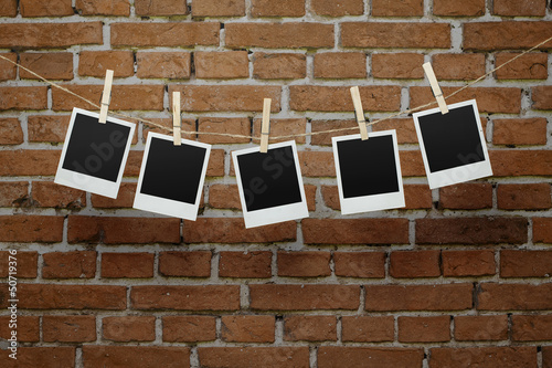 Photo: Blank photos over bricl wall with clipping path for the frames Blank photos over bricl wall with clipping path for the frames