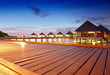 Photo: over water bungalows and villas in ocean at night over water bungalows and villas in ocean at night