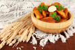 Appetizing village potatoes in bowl on wooden table close-up