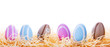Colorful Easter eggs in the nest over white background