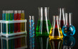 Test tubes with colorful liquids on dark grey background
