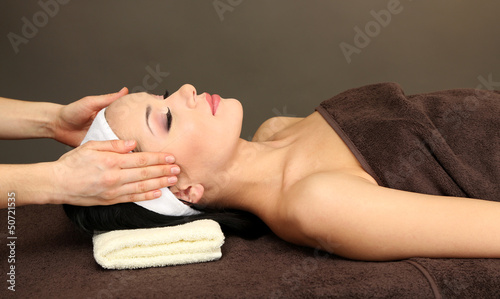 Photo: Beautiful young woman in spa salon taking head massage, Beautiful young woman in spa salon taking head massage,
