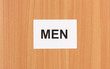 Toilet sign on wooden background