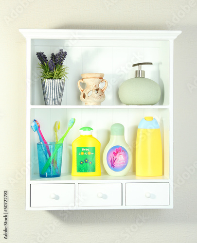 Photo: Beautiful white shelves with different bathroom objects Beautiful white shelves with different bathroom objects
