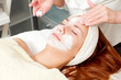 young woman with clay facial mask