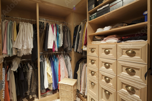 Photo: Walk in closet with organized clothing Walk in closet with organized clothing