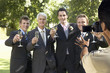 Photo: Man taking a picture of five men toasting with wine glasses at wedding party Man taking a picture of five men toasting with wine glasses at wedding party