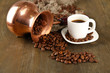 Coffee pot and cup on wooden background