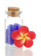 Little bottle full with colorful beads isolated on white