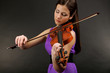 Beautiful young girl with violin on grey background