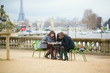 Tourists in Paris planning their trip using map