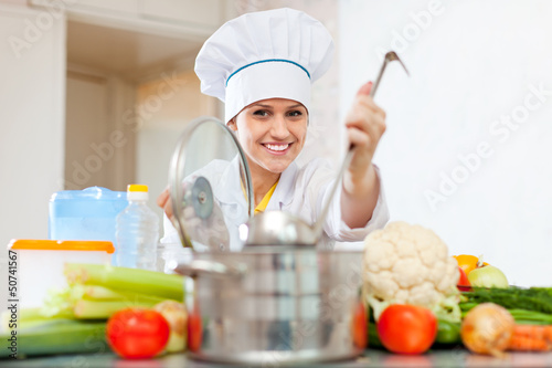 Photo: Happy cook in toque prepares vegetarian lunch Happy cook in toque prepares vegetarian lunch