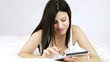 Video: Happy woman writing email on tablet in bed Happy woman writing email on tablet in bed