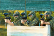 paintball players team aiming markers