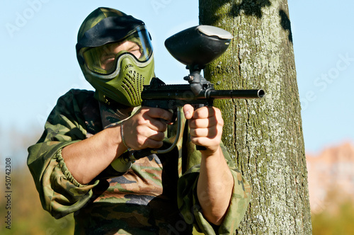 Photo: paintball player holding fire paintball player holding fire