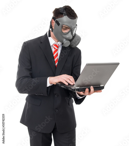 Photo: Busniess man with gas mask using laptop, isolated on white Busniess man with gas mask using laptop, isolated on white