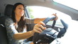 Happy woman talking on the phone while driving