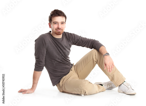 Photo: Flirtatious man sitting on the floor Flirtatious man sitting on the floor