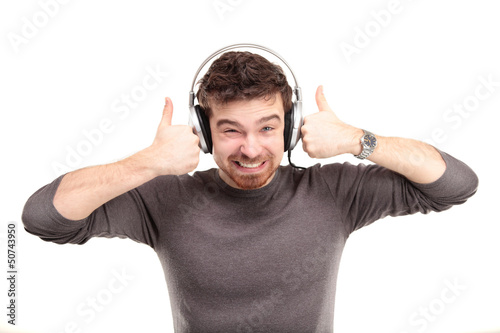 Photo: Attractive young man wearing headphones on white background Attractive young man wearing headphones on white background
