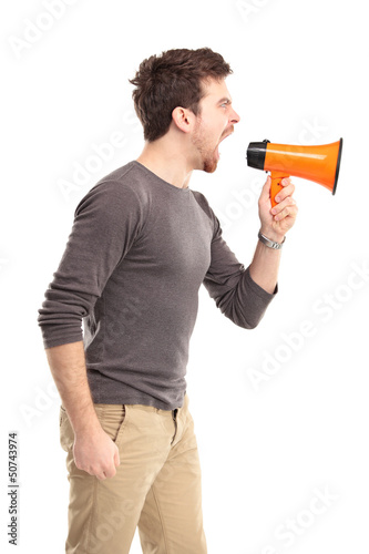 Photo: Young man shouting through megaphone Young man shouting through megaphone
