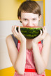 Photo: Girl with short hair eating ripe juicy watermelon Girl with short hair eating ripe juicy watermelon