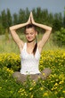 Portrait of a girl in the flower meadow. Woman meditating