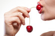 Photo: Young woman with cherry isolated on white Young woman with cherry isolated on white