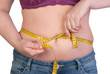 Woman measuring her belly fat