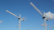 White tower cranes against blue sky. Realtime shot.